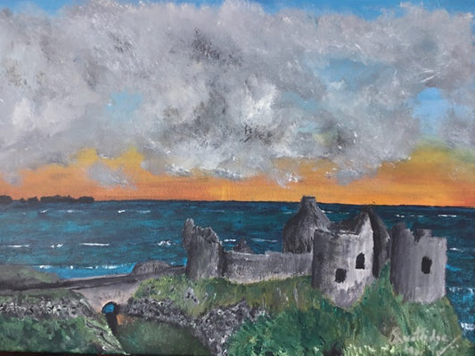 Dunluce Castle at sunset with storm brewing